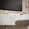 A close-up view of a modern TV cabinet with a television mounted above it. Produktbild-Vorschau