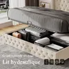 A bed with its storage compartment open, showing luggage and folded linens inside. Podgląd zdjęcia produktu