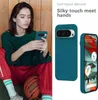 A woman is holding a phone with a teal case, and two teal phone cases are displayed next to her. Produktbild-Vorschau