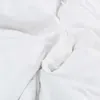 A close-up, abstract view of white fabric, likely a duvet or bedding. Podgląd zdjęcia produktu