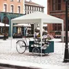 A flower cart under a white canopy on a cobblestone street. Produktbild-Vorschau