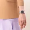 A close-up shot of a person's wrist wearing a silver digital watch. Voir les images du produit