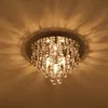 A close-up view of a crystal chandelier hanging from a ceiling, casting light patterns. Produktbild-Vorschau