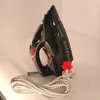 A black and red iron with its power cord and plug. Podgląd zdjęcia produktu
