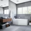 A modern bathroom with a corner bathtub, vanity, and sink. Voir les images du produit