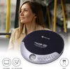A woman is listening to music on a portable CD player while on a bus. Podgląd zdjęcia produktu