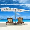 Two people relaxing on lounge chairs under a large umbrella on a tropical beach. Náhled obrázku produktu