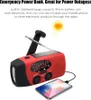 A red and black emergency power bank with a solar panel and radio antenna is shown, with a smartphone connected to it and charging. Podgląd zdjęcia produktu