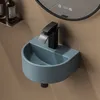 A close-up shot of a compact wall-mounted sink with a black faucet. Anteprima dell’immagine prodotto