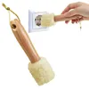 A hand is holding a cleaning tool with a fluffy end near an electrical outlet. Produktbild-Vorschau