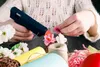 A person is using a hot glue gun to craft decorative flowers. Náhled obrázku produktu