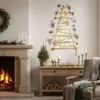 A cozy living room decorated for Christmas, featuring a fireplace, a console table with festive decorations, and a wall-mounted Christmas tree. Náhled obrázku produktu