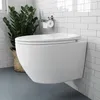 A modern white wall-mounted toilet in a bathroom with white subway tiles and gray flooring. A potted plant is visible to the left, and a toilet paper holder with a roll is mounted on the wall. Náhled obrázku produktu