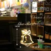 A decorative bell-shaped LED light hanging in what appears to be a cafe or shop. Produktbild-Vorschau