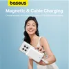 A woman is holding a white power bank attached to a smartphone. Produktbild-Vorschau