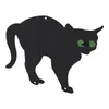 A silhouette of a black cat with green eyes on a white background. Voir les images du produit