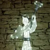 A lighted angel decoration against a stone wall. Náhled obrázku produktu
