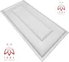 A white, textured wall panel with a raised rectangular design in the center, shown at an angle on a white background. Two identical logos with the text 'IKHE MALARKA' are present in the top right and bottom left corners. Produktbild-Vorschau