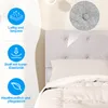 A close-up view of a gray fabric bed frame headboard with a pillow and bedding. Produktbild-Vorschau