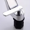 A close-up view of a chrome faucet handle and base. Podgląd zdjęcia produktu