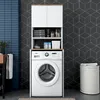 A bathroom with a washing machine and storage unit. Voir les images du produit