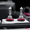 Two automotive halogen bulbs are displayed on a white platform. Podgląd zdjęcia produktu