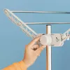 A hand is shown adjusting a knob on a drying rack. Náhled obrázku produktu