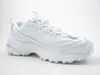 A white athletic shoe is shown from the side against a white background. Voir les images du produit