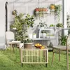 A patio scene with a coffee table, chairs, and numerous plants. Anteprima dell’immagine prodotto