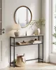 A narrow console table with two shelves is placed in an entryway, decorated with a lamp, books, and a basket. Produktbild-Vorschau