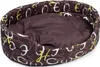 A brown oval pet bed with a pattern of white and yellow letters. Produktbild-Vorschau