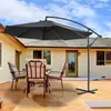 A patio set with chairs and a large umbrella on a wooden deck, with a house in the background. Voir les images du produit