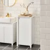 A white bathroom cabinet with a laundry basket is shown next to a sink. Produktbild-Vorschau
