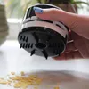 A hand holding a mini-table vacuum cleaner over a surface with crumbs. Anteprima dell’immagine prodotto