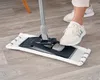 A person is using a mop to clean a wooden floor. Produktbild-Vorschau