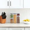 A kitchen counter with storage containers, knives, and lemons. Anteprima dell’immagine prodotto