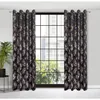 A pair of black curtains with a gold leaf pattern hangs in front of a window. Produktbild-Vorschau