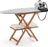 An ironing board with an iron and steam generator attached, set against a white background. There are folded towels on a shelf below the ironing board. Produktbild-Vorschau