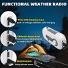 A weather radio is shown in a camping setting at night, with a tent and a phone charging. Produktbild-Vorschau