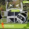 A two-story rabbit hutch with an arched roof is shown in a grassy outdoor setting. Produktbild-Vorschau