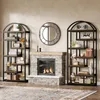 A living room scene featuring a fireplace, two tall bookshelves, and a round mirror above the fireplace. Náhled obrázku produktu