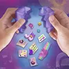 Hands holding two halves of a purple crystal, with various small colorful gems, stickers, and accessories scattered around them. Náhľad obrázku produktu