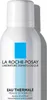 A close-up shot of a white spray bottle with blue accents and text. Voir les images du produit