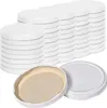 Stacks of white jar lids are arranged in rows, with two lids in the foreground showing the inside. Produktbild-Vorschau