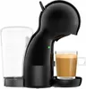 A black capsule coffee machine with a clear water tank and a glass of coffee. Podgląd zdjęcia produktu