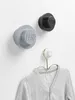 Three LEGO-themed wall hooks mounted on a white wall, with a grey cardigan hanging from the bottom hook. Produktbild-Vorschau