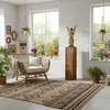 A bright and airy living room with a wooden decorative column, a rattan chair, plants, and a patterned rug. Voir les images du produit