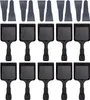 A top-down view of multiple raclette grill pans and spatulas arranged in rows on a white background. Produktbild-Vorschau