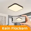 A square LED ceiling light is shown on a white ceiling, with a smartphone in the foreground displaying a reflection of the light. Voir les images du produit