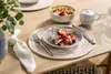 A breakfast setting on a wooden table with French toast, fruit, and coffee. Produktbild-Vorschau